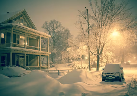 house and car covered in snow